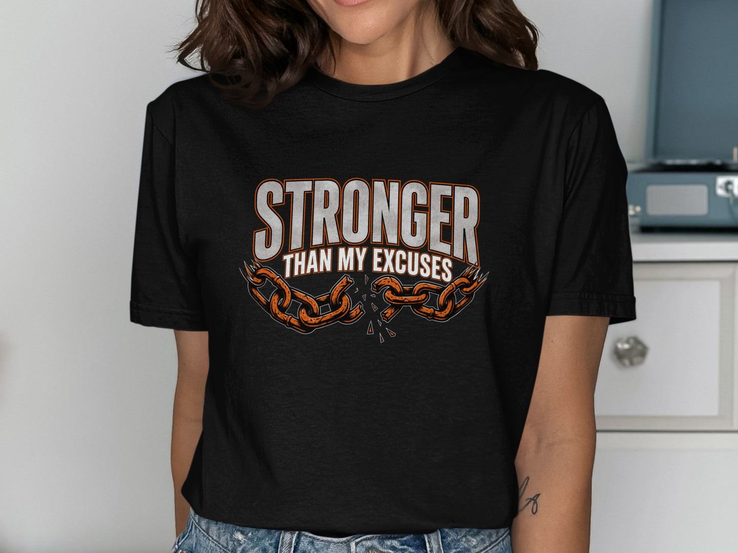 Black t-shirt with "Stronger Than My Excuses" and broken chain design.