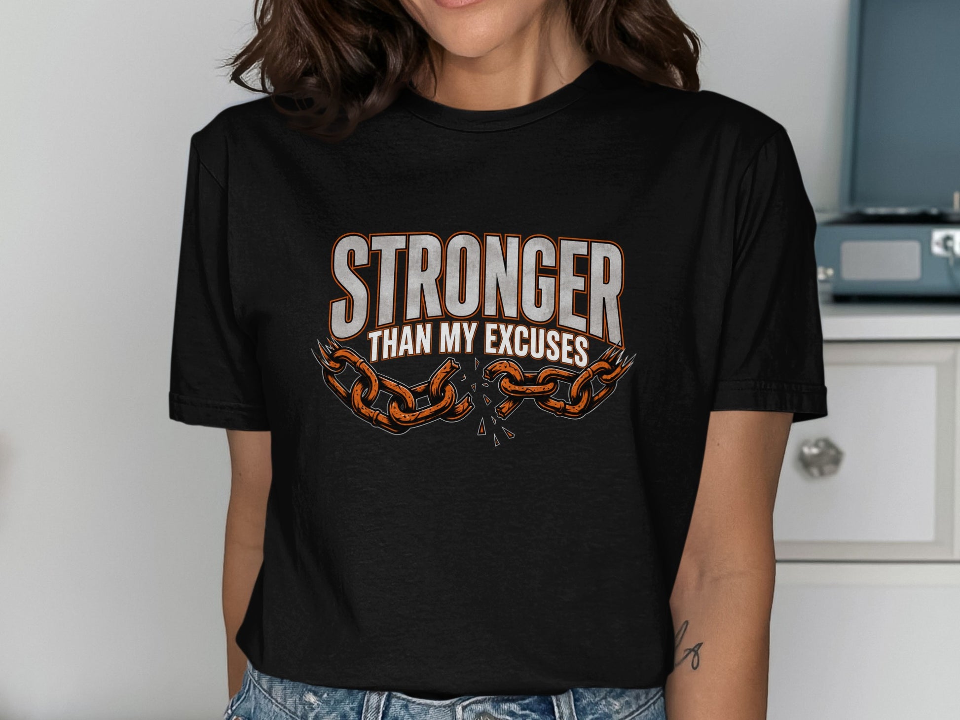 Black t-shirt with "Stronger Than My Excuses" and broken chain design.