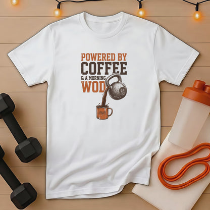 White t-shirt with text "Powered by Coffee & a Morning WOD" and kettlebell pouring coffee.